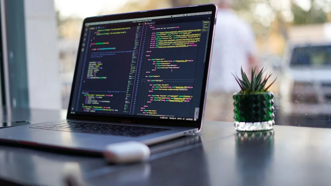 Two monitors on a desk, displaying web design in a contemporary office environment.